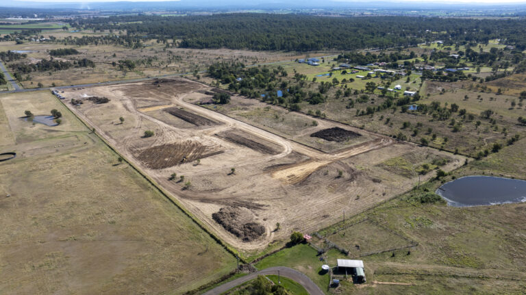 Ongoing civil works at Laidley Plainland Road, Plainland, showcasing road construction, tree clearing, and underground service installation for a rural residential subdivision.