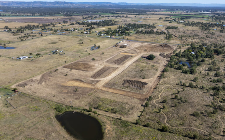 Ongoing civil works at Laidley Plainland Road, Plainland, showcasing road construction, tree clearing, and underground service installation for a rural residential subdivision.