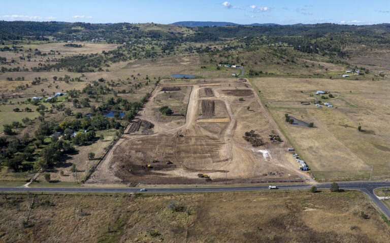 Ongoing civil works at Laidley Plainland Road, Plainland, showcasing road construction, tree clearing, and underground service installation for a rural residential subdivision.