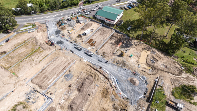 Aerial view of the completed residential subdivision at Gilston Road, Gold Coast, showcasing roadworks, underground services, and cleared development areas.