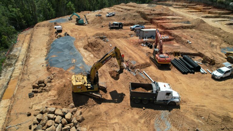 Ongoing civil works at Baileys Mountain Road, Upper Coomera, featuring road construction, underground services, and stormwater treatment tanks for an 85-lot townhouse development.