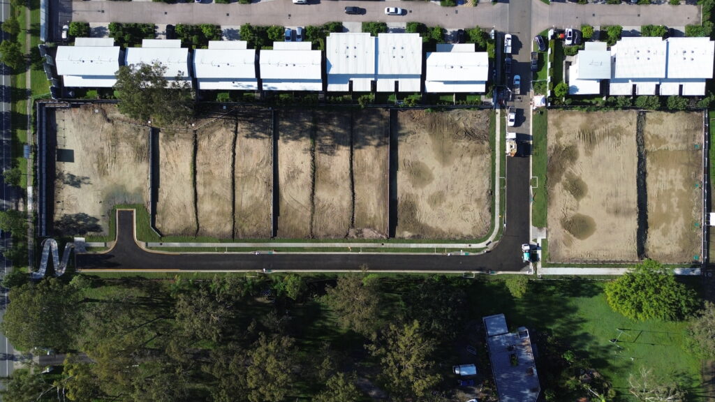 Aerial view of the completed residential subdivision at Beckett Road, Bridgeman Downs, showcasing roadworks, underground services, and site preparation.