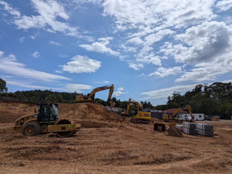 Ongoing civil works at Baileys Mountain Road, Upper Coomera, featuring road construction, underground services, and stormwater treatment tanks for an 85-lot townhouse development.
